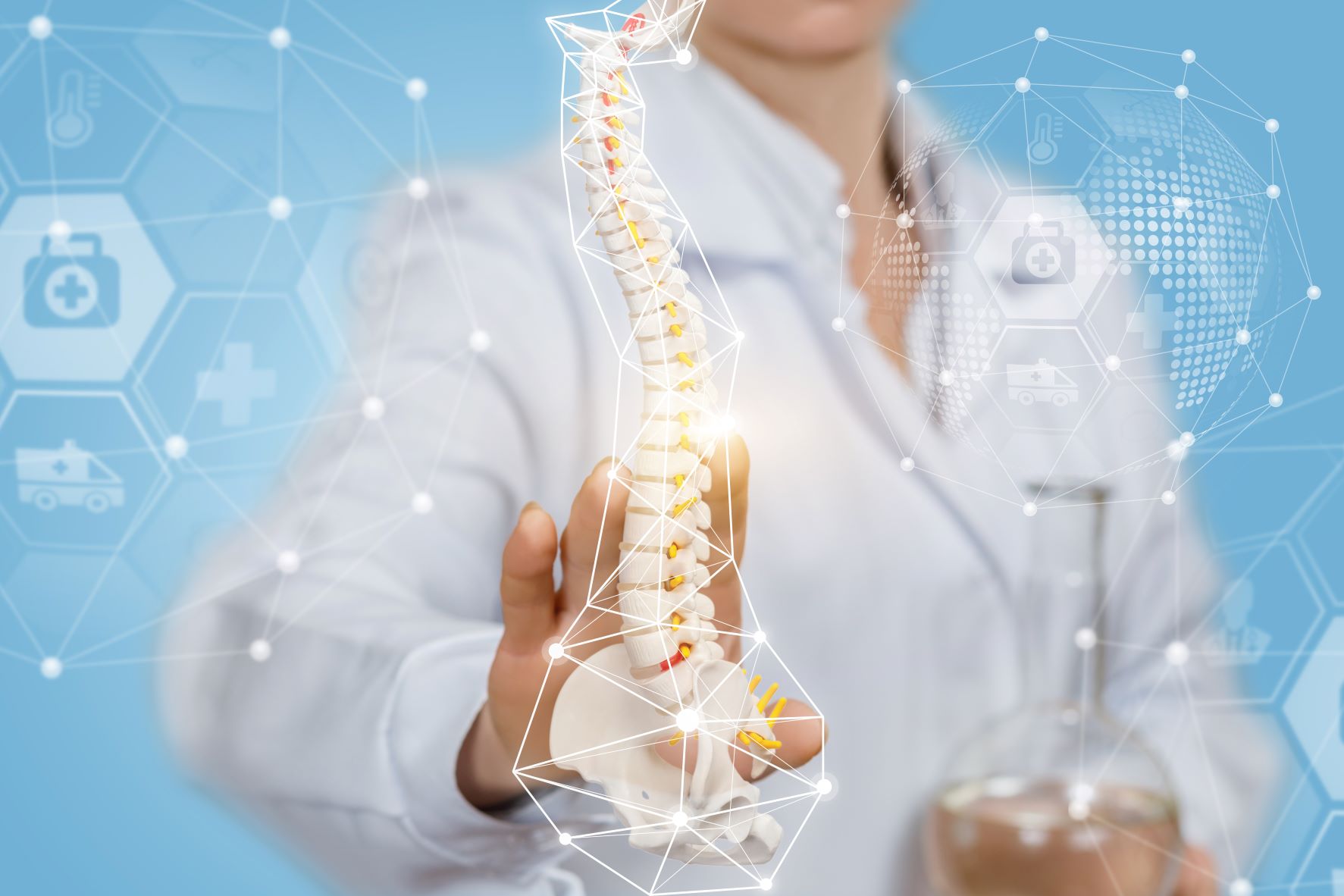 Stock Image of Scientist Holding Model of Human Spine with Graphical Overlays Evoking the Medical Industry