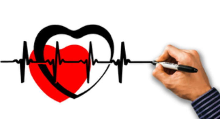 Stock Image of a Hand Drawing a Heartbeat Echo Over a Heart