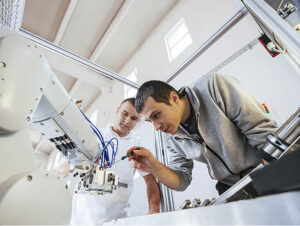 Two Technicians Calibrating Robotic Arm